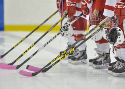 SAIT Trojans Women's Hockey Team - pink tape on hockey sticks 2015