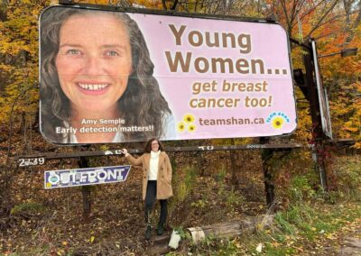 Amy standing by one of her campaign signs in Peterborough
