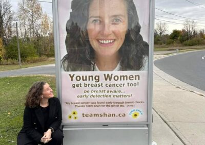 Amy looking at one of her campaign signs at a bus stop in Peterborough